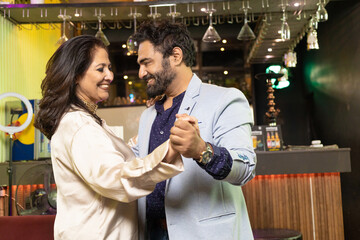 Indian couple dancing at restaurant