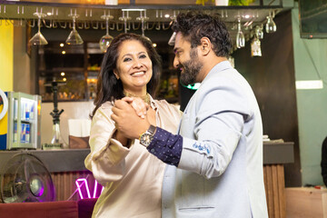 Indian couple dancing at restaurant