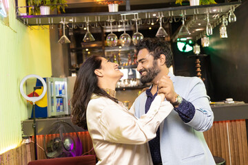 Indian couple dancing at restaurant