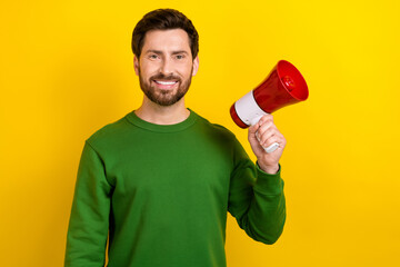 Photo of young smiling boss man hold megaphone will speech his next announcement about company results isolated on yellow color background