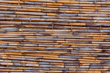 Detailed texture of a bamboo or reed fence.
