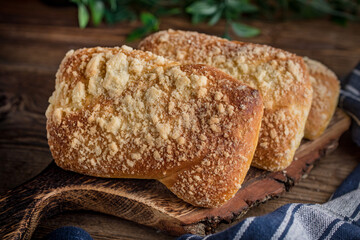 Sweet buns with cheese on wooden table.
