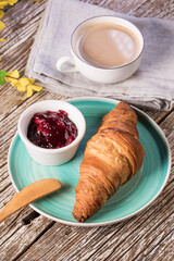 Fresh croissant on wooden board.