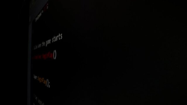 Closeup macro shot movement of coding script moving across LED screen with real-time AI-generated typing, showcasing advanced AI learning in optimization, debug and coding for software development.