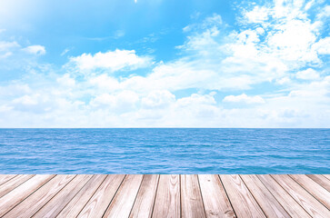 Empty wooden table for displaying products. The background is sea view, blue sky, white clouds. (with copy space)	
