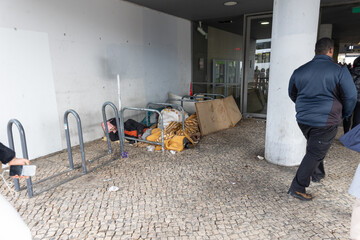 Homeless people sleeping on the street by the bike stops