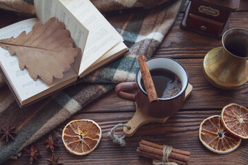 Autumn mood, autumn atmosphere. A cup of hot coffee, a plaid blanket, a coffee mill, cinnamon...