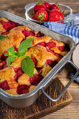 Yeast cake with strawberry in a mold.