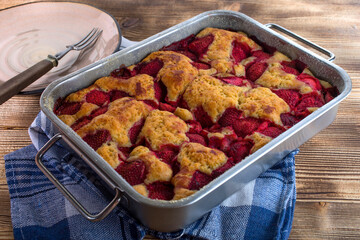 Yeast cake with strawberry in a mold.