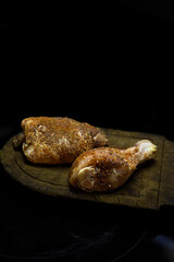 Raw seasoned chicken thigh and leg.
