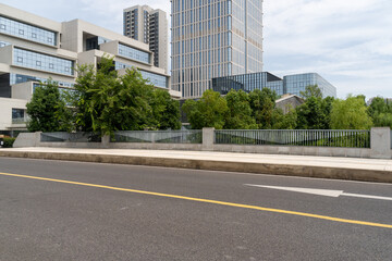 empty asphalt road in modern city with office buildings as background.