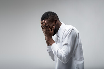 Young black man depressed; mental healthcare needed - obrazy, fototapety, plakaty