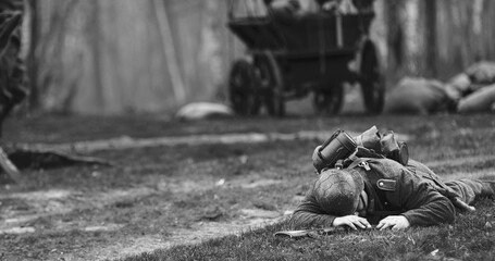 German Infantry Soldier In World War Ii. Re-enactor Dressed As German Wehrmacht Soldier Lies Slain In Reconstruction Of Battles World War Ii. Win Of Soviet Army In War. Black And White .