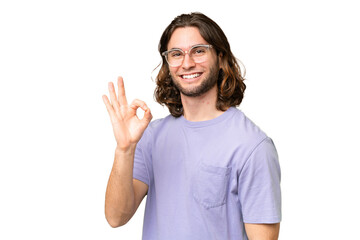 Young handsome man over isolated background showing ok sign with fingers