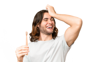 Young handsome man brushing teeth over isolated background has realized something and intending the solution