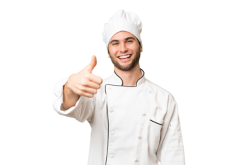 Young handsome chef man over isolated background with thumbs up because something good has happened