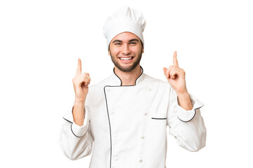 Young handsome chef man over isolated background pointing up a great idea