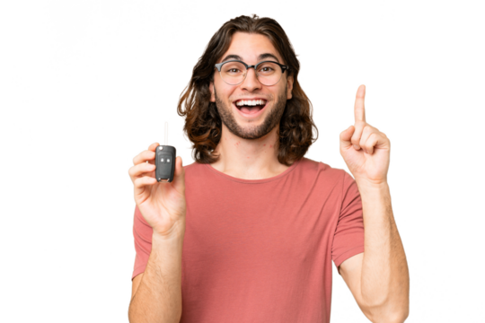 Young handsome man holding car keys over isolated background pointing up a great idea