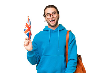 Young handsome man holding an United Kingdom flag over isolated background with surprise facial expression - obrazy, fototapety, plakaty