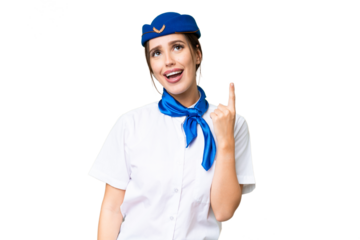 Airplane stewardess over isolated chroma key background pointing up and surprised