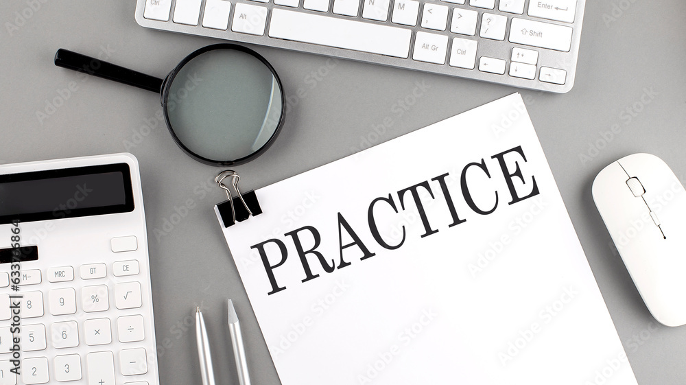 Aufkleber practice written on paper with office tools and keyboard on the grey background