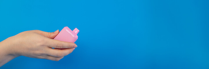 disposable vape, electronic cigarettes, smoking devices on a blue background, copy space, banner