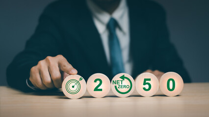 Concept, goal of NET ZERO, air pollution reduction and environmental conservation, businessman hand touching round stick Demonstrates an end to environmentally destructive carbon emissions by 2050