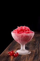 Red currant sorbet granita in glass creamer covered hoarfrost
