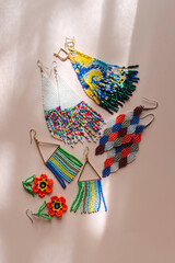 Trendy different  beaded earrings. Hand weaving beading  jewelry. Needlework and beading concept. Creativity and  hobby