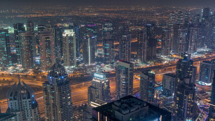 JLT and Dubai marina skyscrapers near Sheikh Zayed Road aerial day to night timelapse. Residential buildings