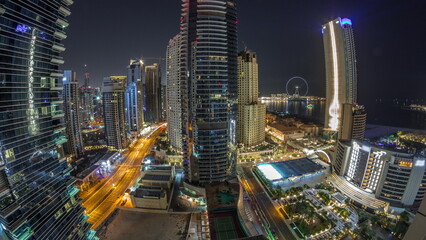 Fototapeta na wymiar Panoramic view of the Dubai Marina and JBR area and the famous Ferris Wheel aerial night timelapse