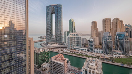 Fototapeta na wymiar Dubai Marina skyscrapers and JBR district with luxury buildings and resorts aerial night to day timelapse