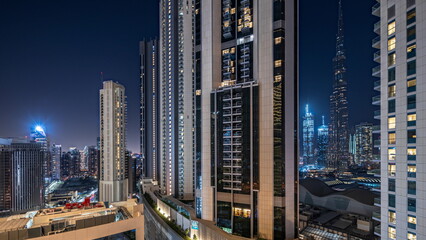 Tallest skyscrapers in downtown dubai located on bouleward street near shopping mall aerial night timelapse.