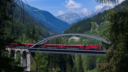 Railjet express crossing river Trissnana near to city names Landeck in austrian alps. © Honza
