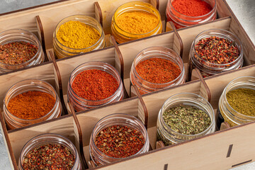 A set of spices on a light background in a glass bowl. Enhancement of taste.