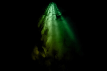 Green colored smoke on a black background, abstract cloud. Abstract green lighting.