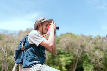 Asian man sitting and traveling on a bridge Take fun photos and videos. Rivers and mangroves
