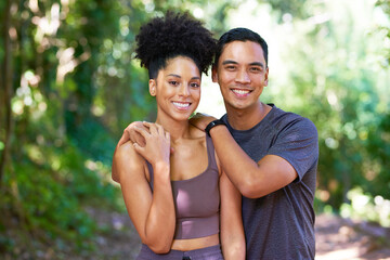 Happy young couple pose in forest in active wear, fitness trail run hiking - Powered by Adobe
