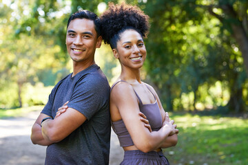 Beautiful young multi-ethnic couple exercise together in park, pose and smile