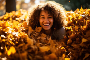 A woman playing in a pile of leaves 