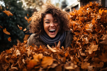 A woman playing in a pile of leaves