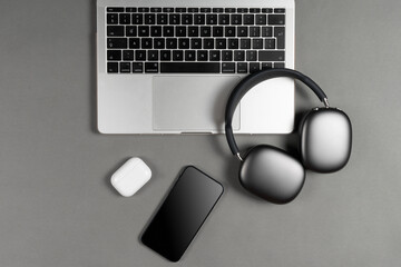 Mockup set of modern gadgets on a beautiful sky blue or blue background with headphones, laptop, phone, joystick and camera  © Ivan