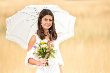 young woman with white dress and flowers and umbrella