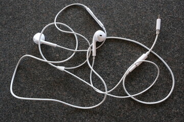 Close up of tangled earphones on table