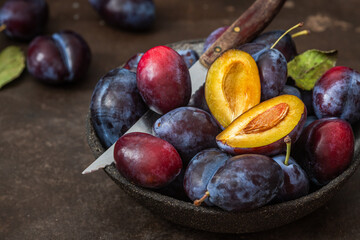 Fresh, ripe plums in a plate on the table