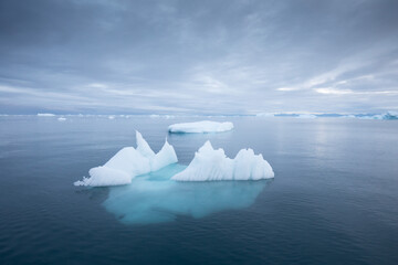 Iceberg at sunset. Nature and landscapes of Greenland. Disko bay. West Greenland. Summer Midnight...