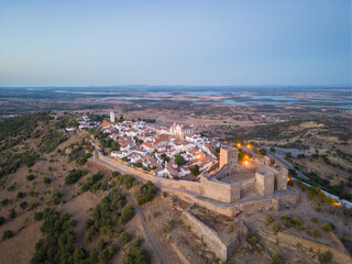 Aerial view of the Monsaraz Castle on a hill at sunset, Portugal