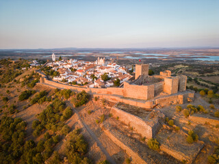 Aerial view of the Monsaraz Castle on a hill at sunset, Portugal