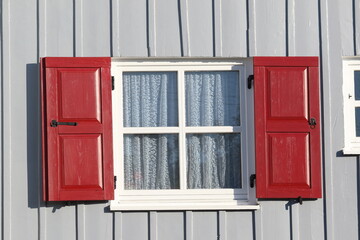 red window on a gray wall, 