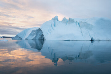 Melting of a iceberg and pouring water into the sea by the coast of Greenland Greenland and amazing iceberg on the sea, we can still see this before complete climate change. Icefjord Global warming. © Michal